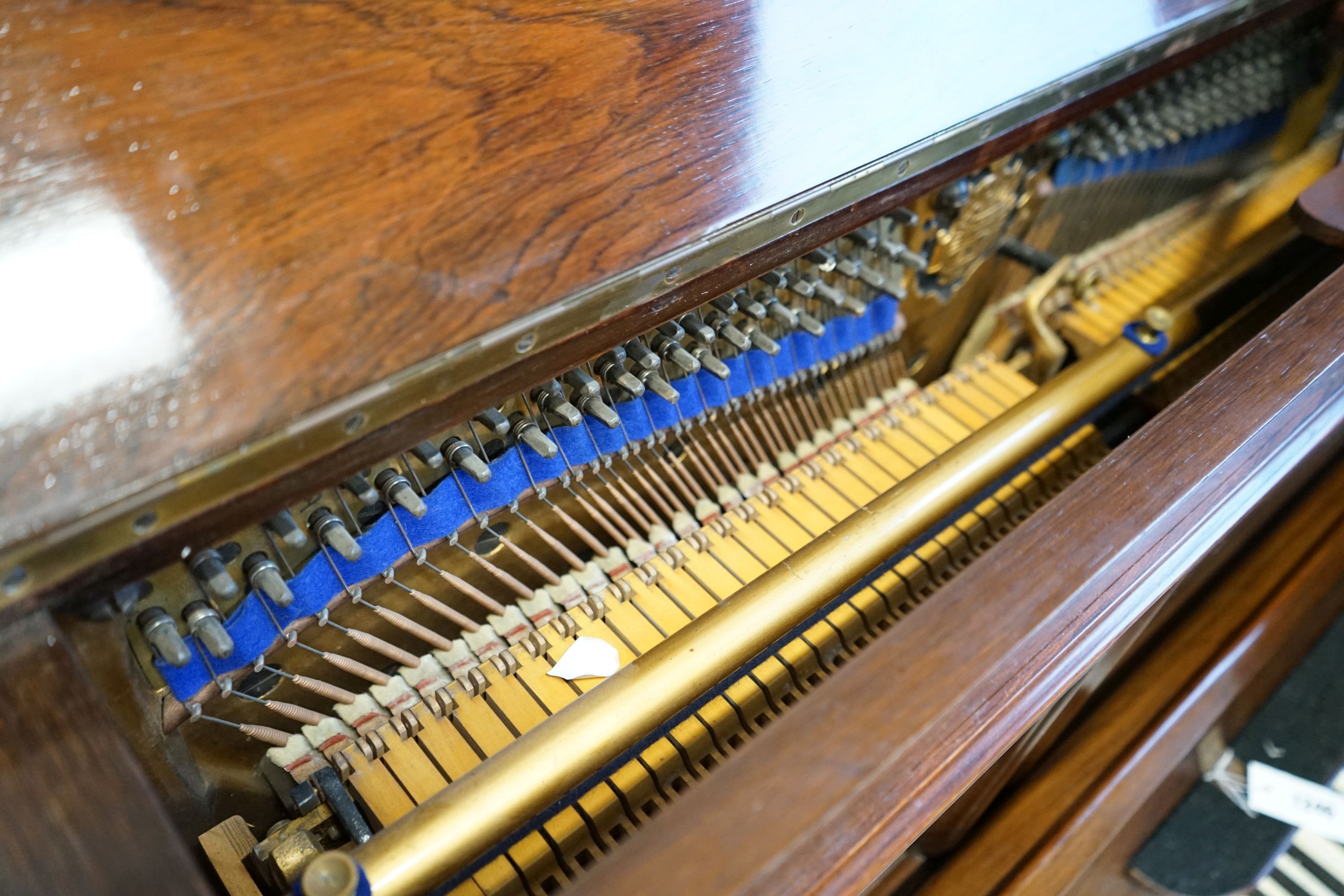 An early 20th century walnut cased Bluthner upright piano, Serial Number 92280